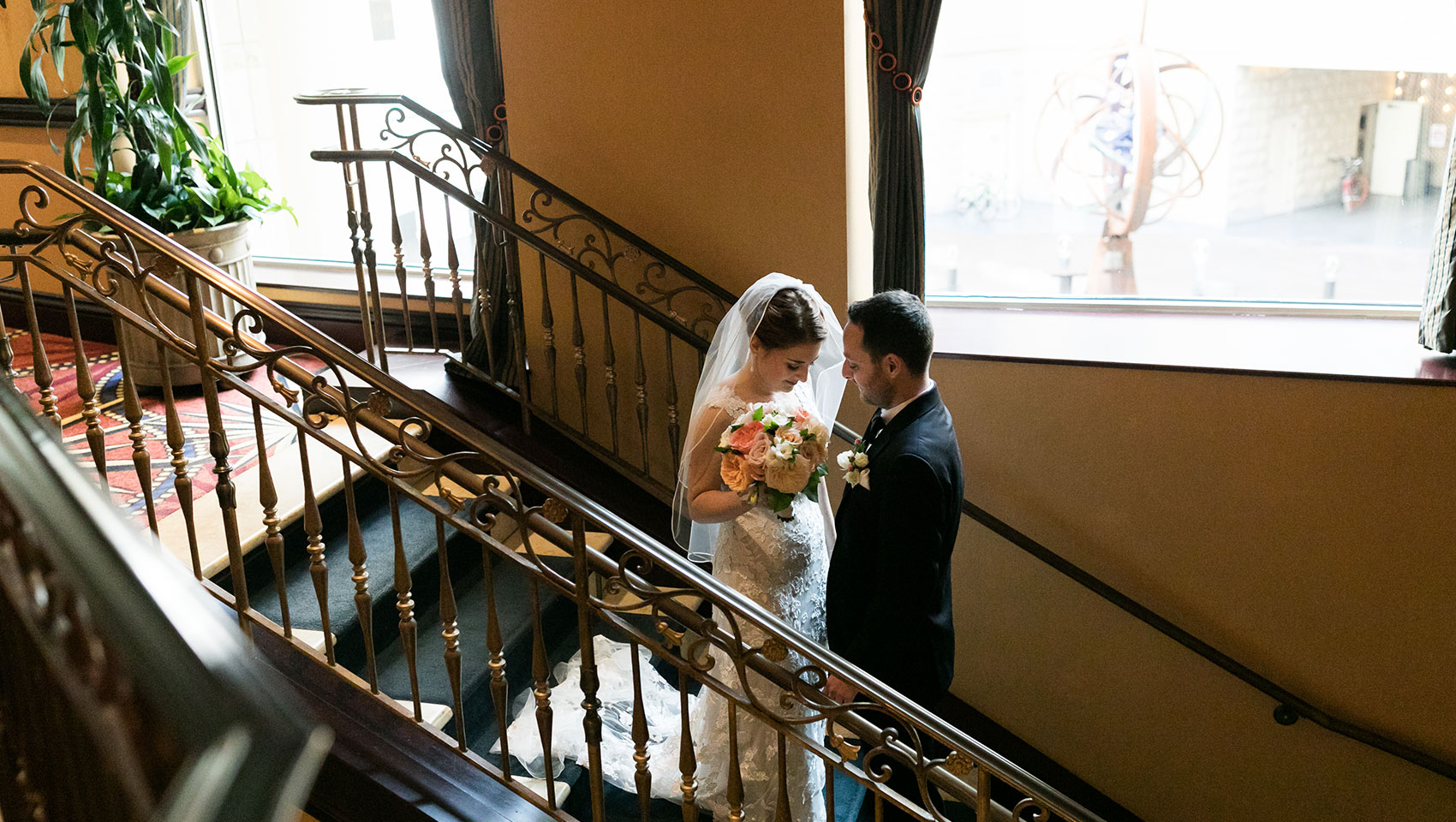 Bride and Groom on staircase in wedding attire