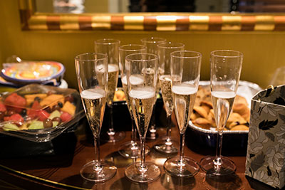 Glasses with champagne on table with snacks