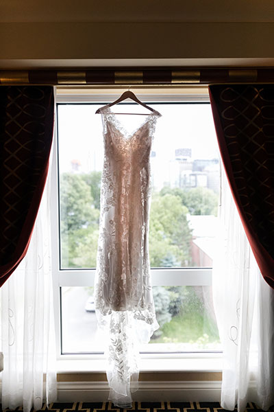 Wedding dress hung by window