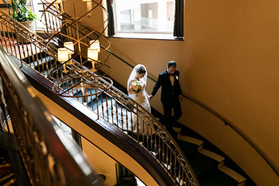 Wedding couple walking down stairs