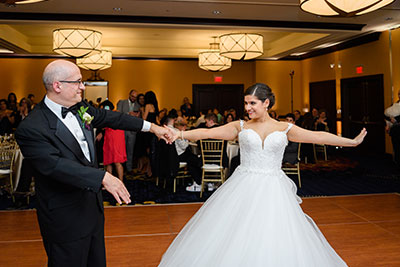 Bride dancing with man