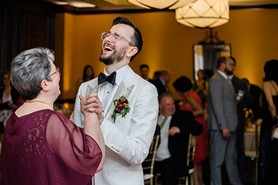 Groom laughing while dancing
