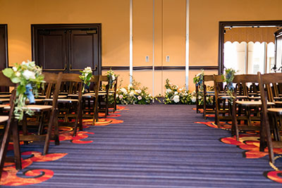Wedding aisle with chairs and floral pieces