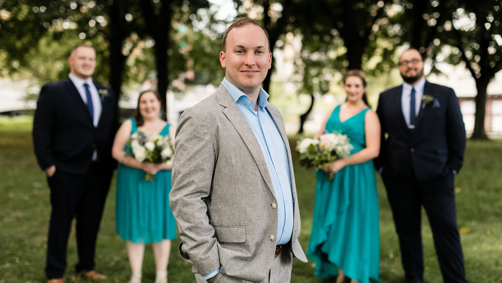 Groom in front of wedding party