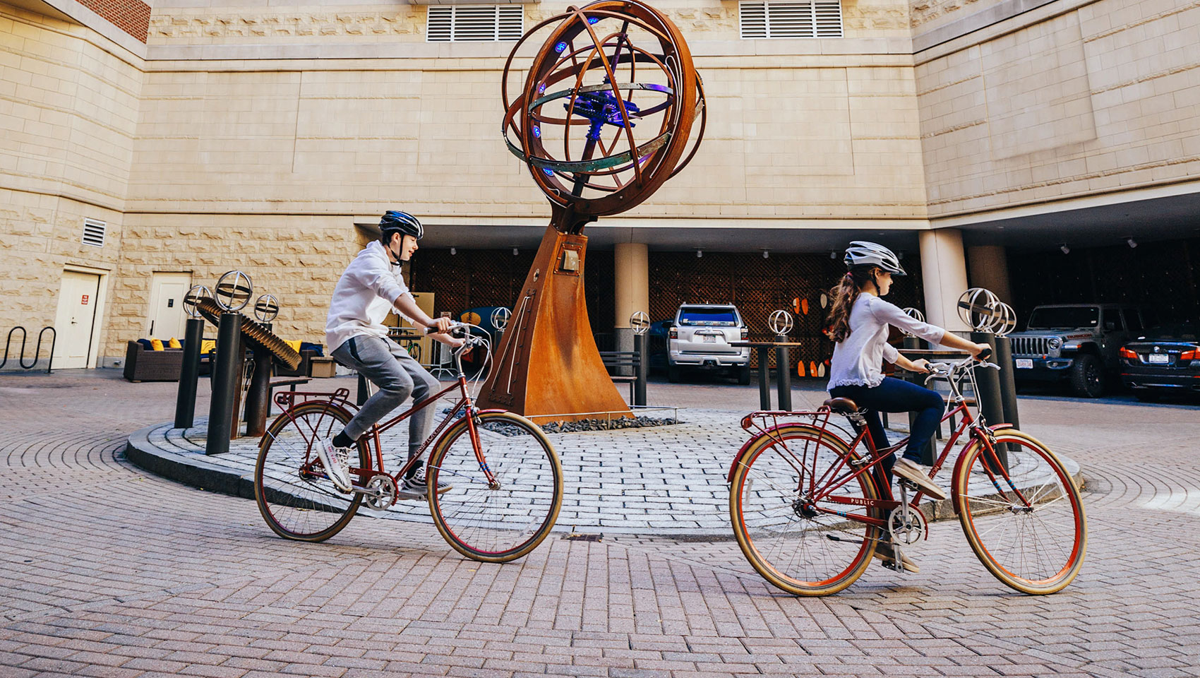 Two people riding bicycles in front of Marlowe