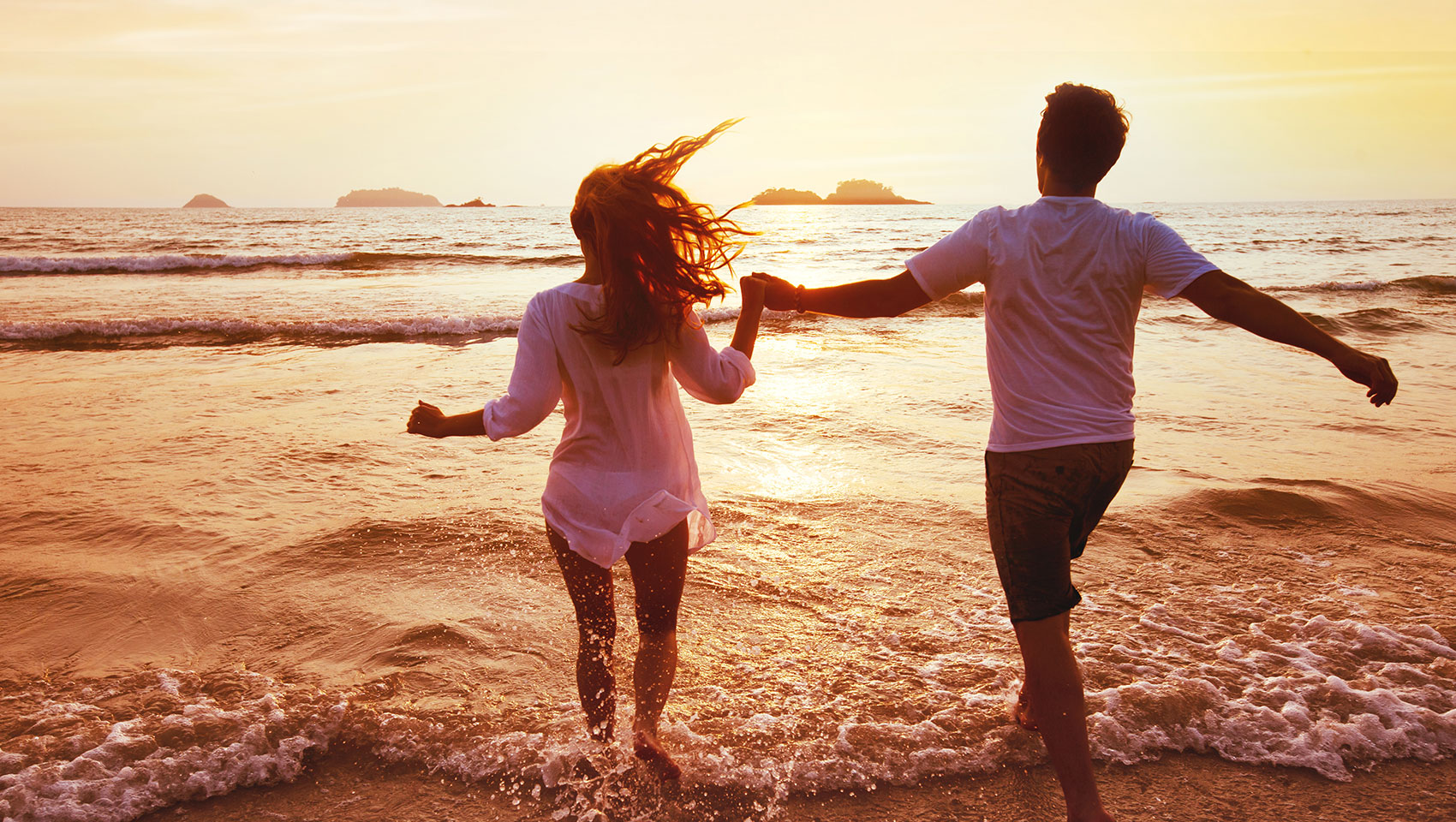 Couple frolicking on beach
