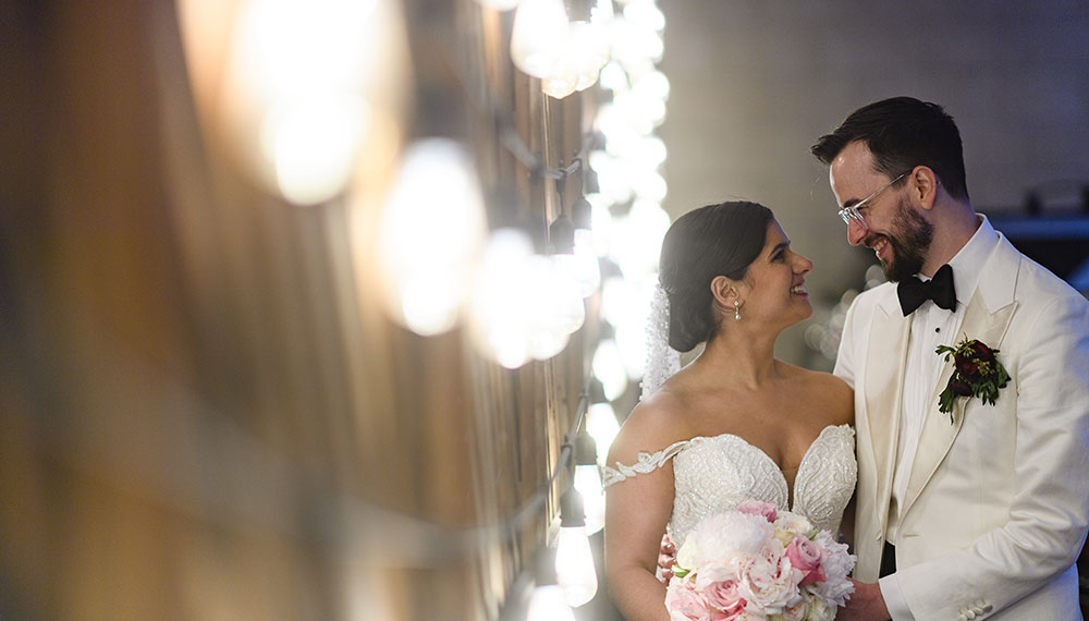 Wedding couple looking at each other next to bright lights