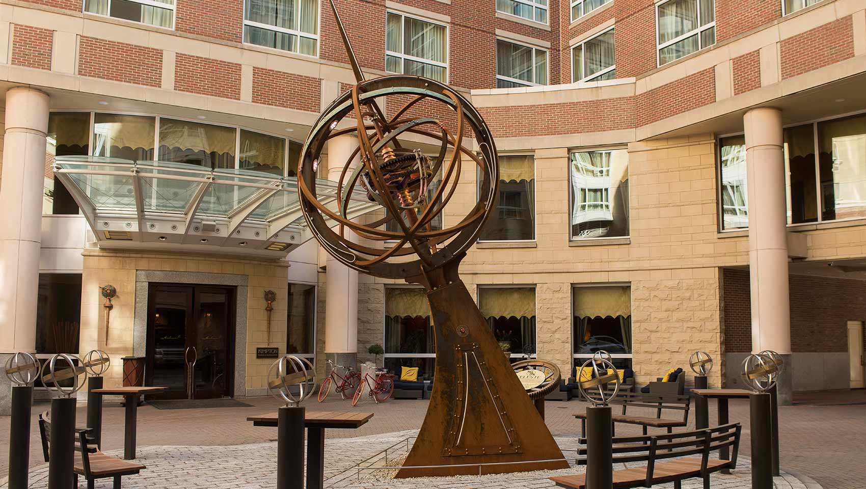 Kimpton Marlowe Hotel courtyard with sphere shaped, metal art fixture, Celeste, in the middle.