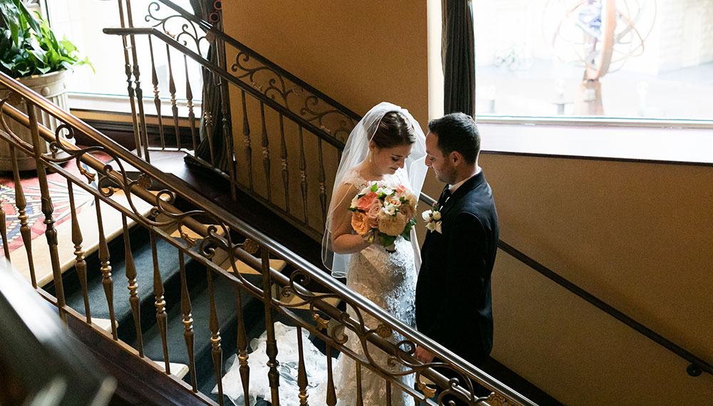 Bride and Groom on staircase in wedding attire