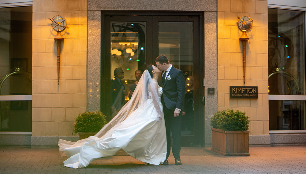 Bride and Groom kissing by the river