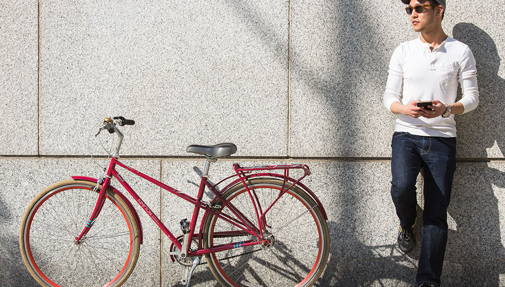 man standing next to Kimpton PUBLIC bike