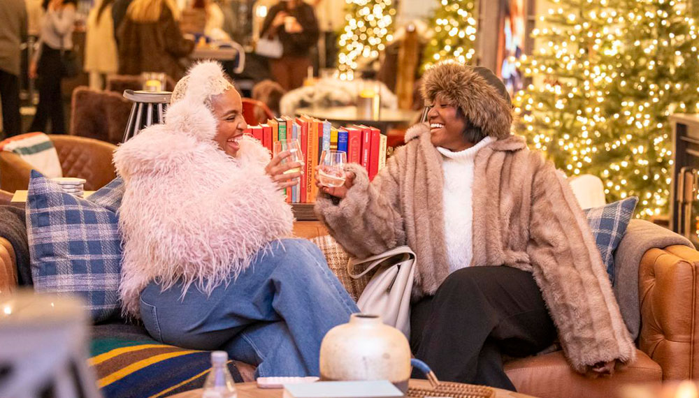two people sitting on a couch in the Frostival Lodge