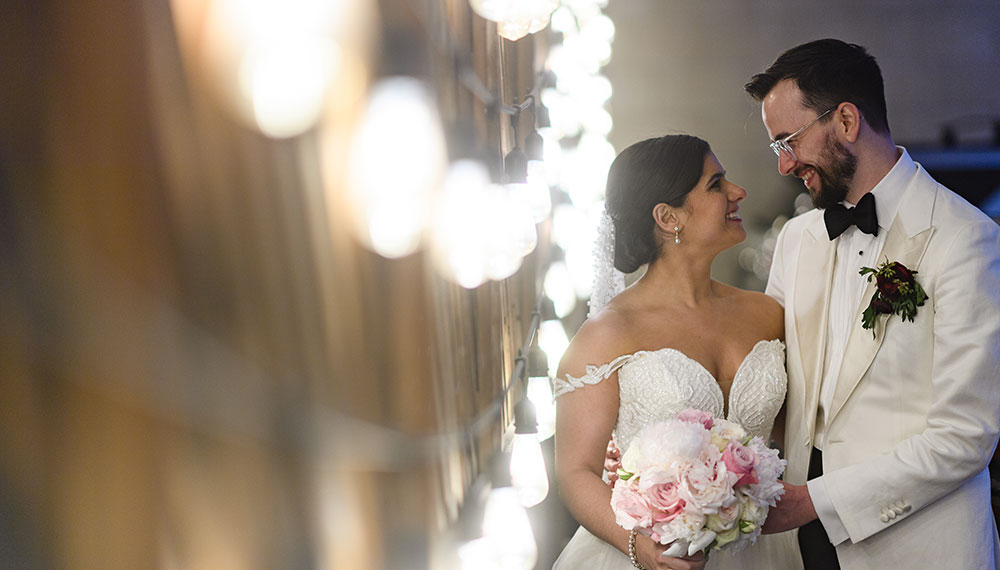 Wedding couple looking at each other next to bright lights