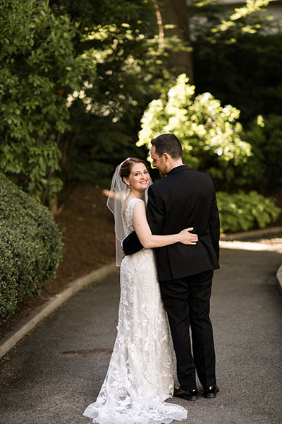 Wedding couple with bride looking back at camera 