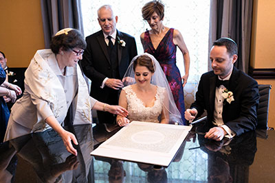 Wedding couple at table with family