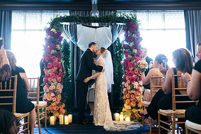 Wedding couple kissing at altar