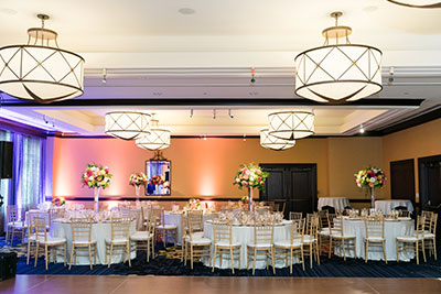 Wedding tables set up in ballroom