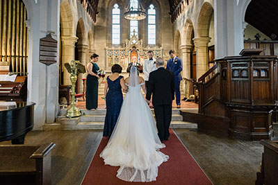 Bride walking down aisle in church