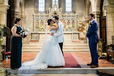 Wedding couple kissing at altar