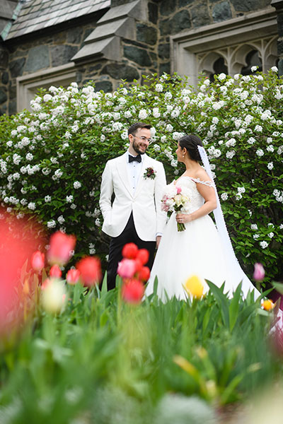 Wedding couple posing with flowers