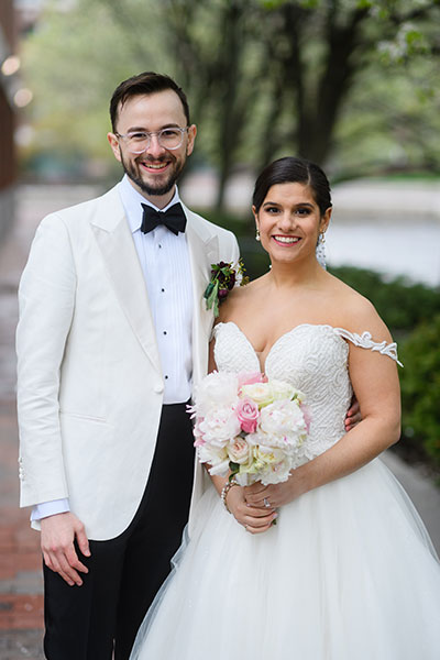 Wedding couple posing with bouquet 