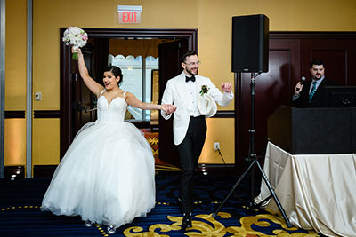 Wedding couple dancing into hall