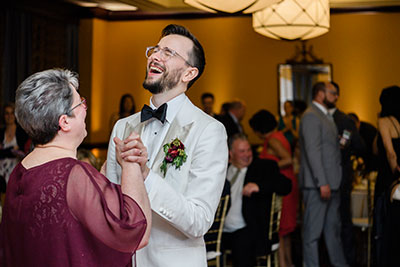 Groom laughing while dancing