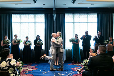 Grooms kissing at altar