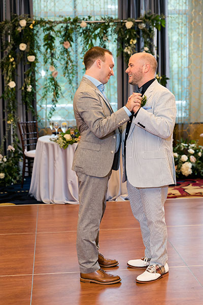 Grooms dancing together