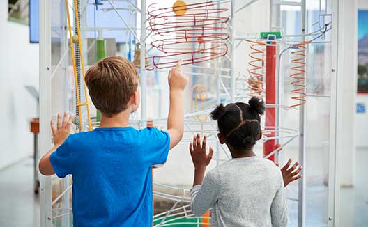 kids drawing on a whiteboard